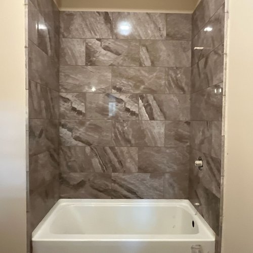 Marble tile shower walls in McFarland, WI by Bisbee's Flooring Center
