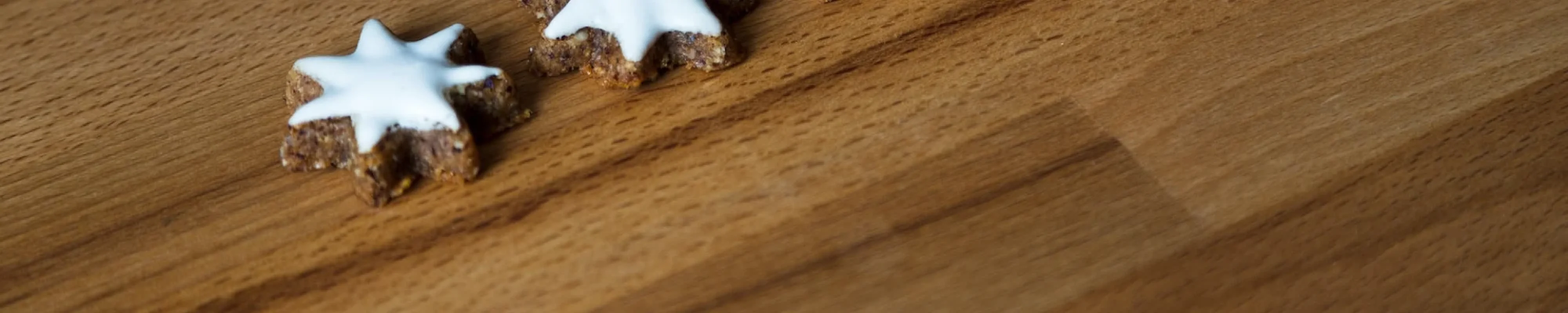 Hardwood floor surface with white star shaped cookies